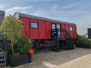 Converted Railway Carriage Truck next to a Steam Railway Line